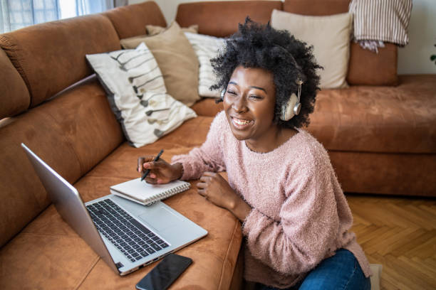 istock Beautiful young woman working at home and using laptop 1299417056