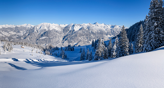 Snowy winter landscape with perfect conditions for skiing in ski resort. Photographed in Brandnertal, Vorarlberg, Austria.