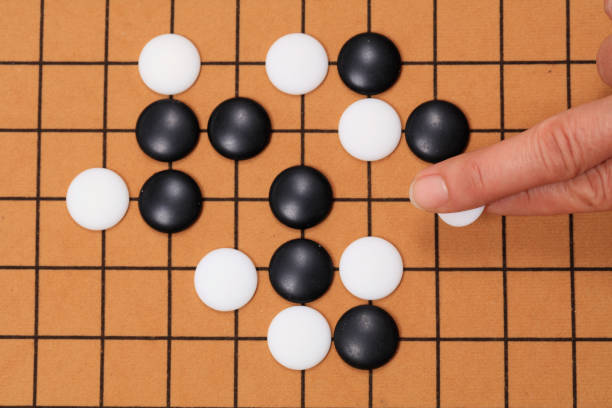 istock chinese game go,  Gobang and go game board 1299420050