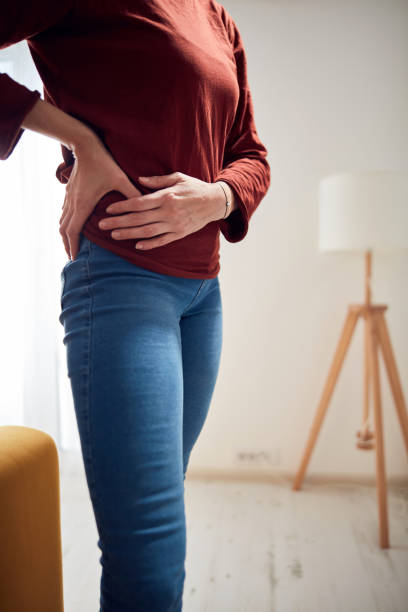 istock Woman with strong hip pain at home. 1299421530