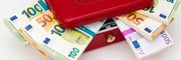 cash box with bundles of Euro banknotes