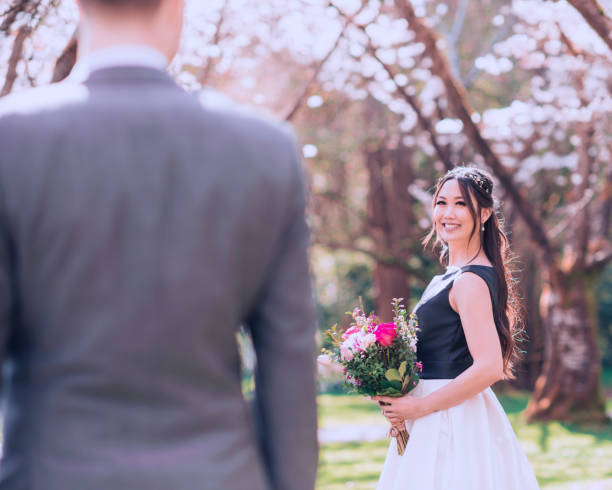 istock Bride with boho style bouquet looking at husband with love 1299424629