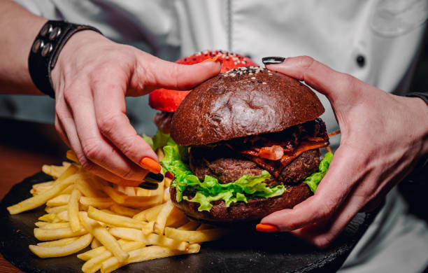 istock woman hands holding fresh delicious burger 1299427110