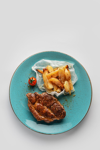 Grilled Steak With French Fries From Above on a Plate
