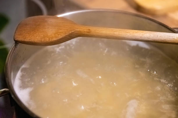 istock cooking pot with water and wooden spoon 1299428263