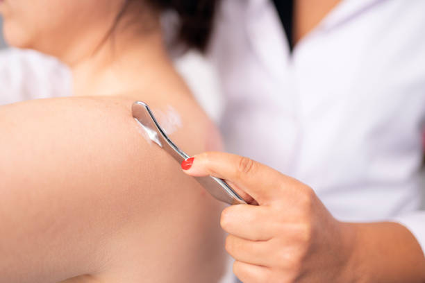 istock Female physiotherapist is examining to her patient. 1299429358