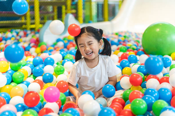 istock Cute girl at the Ball Pool 1299431486