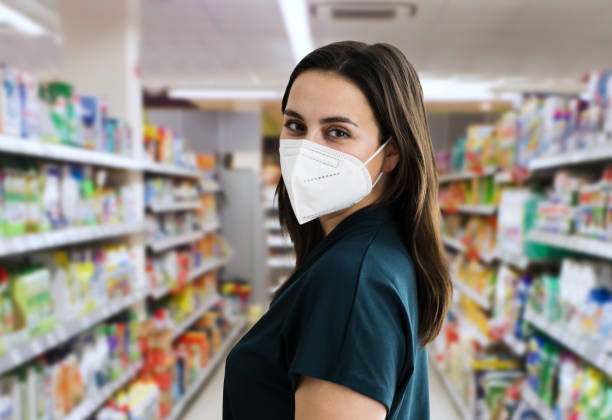 Woman Shopping In Face Mask Young Customer Woman Shopping In Face Mask kn95 face mask photos stock pictures, royalty-free photos & images