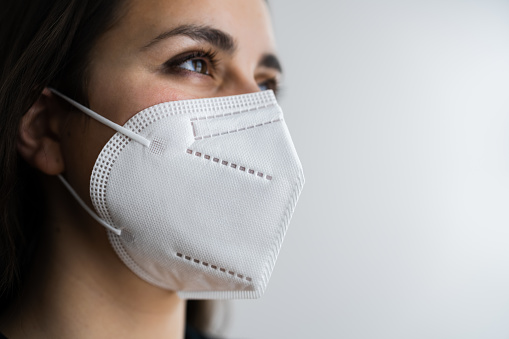 Receptionist Woman In Medical FFP2 Face Mask