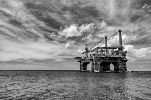 Black and white image of an oil rig.