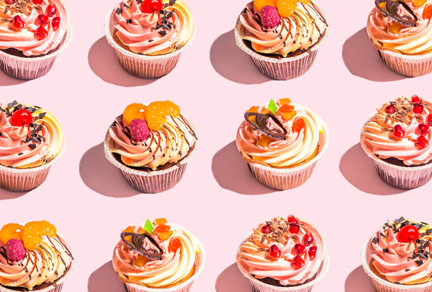 Tasty colorful cupcakes on pink background stock photo