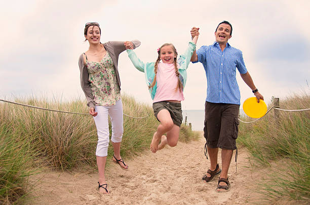Family walking together on beach  dorset england photos stock pictures, royalty-free photos & images