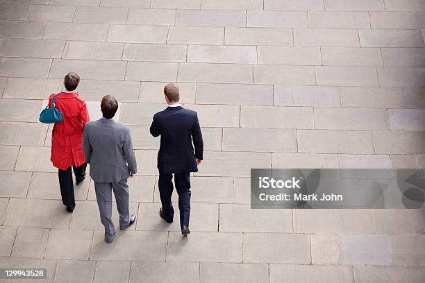 Business People Walking In Courtyard Stock Photo - Download Image Now - High Angle View, Rear View, Walking