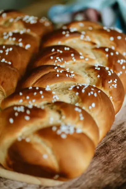 Fresh baked sweet braided yeast bun, food still life