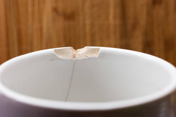 Chipped ceramic cup macro close up shot in the kitchen.