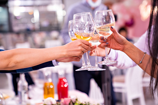 hands with a glass of wine. toast at the party. alcohol consumption. Holiday. Sommelier.