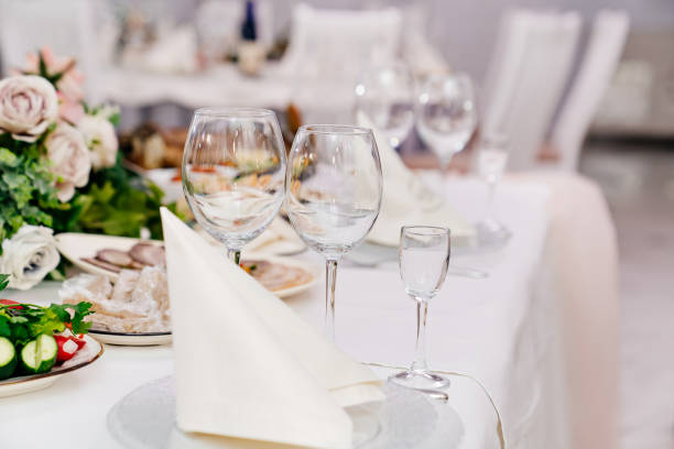 istock empty wine glasses. serving a table for celebration in a cafe 1299438552