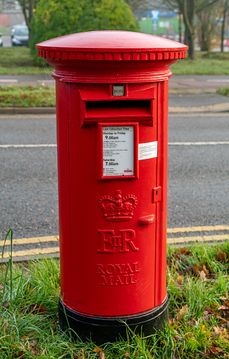 Red post box of Posten Norge (The Norwegian Post) in Bergen. Posten was founded in 1647.