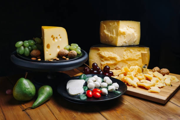 istock Composition different types of cheese with walnuts and grapes on rustic wooden background 1299439418