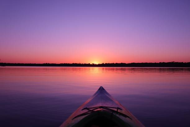 bunte kajak sonnenuntergang - environment nature tranquil scene nautical vessel stock-fotos und bilder