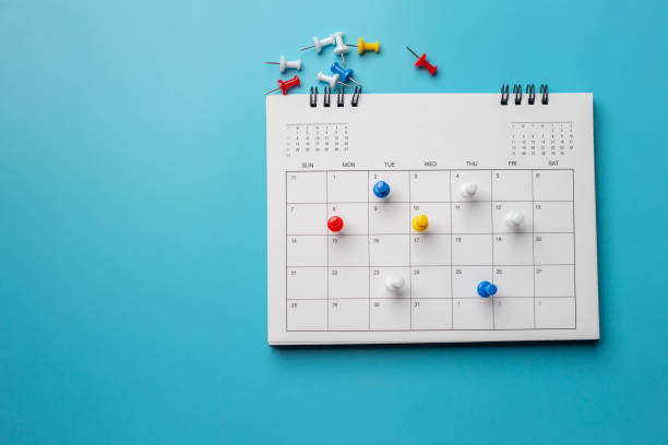 istock Calendar on solid blue background with copy space, pinned in a calender on datebusiness meeting schedule. 1299442914