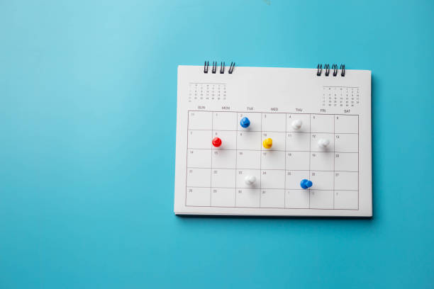 istock Calendar on solid blue background with copy space, pinned in a calender on datebusiness meeting schedule. 1299442934