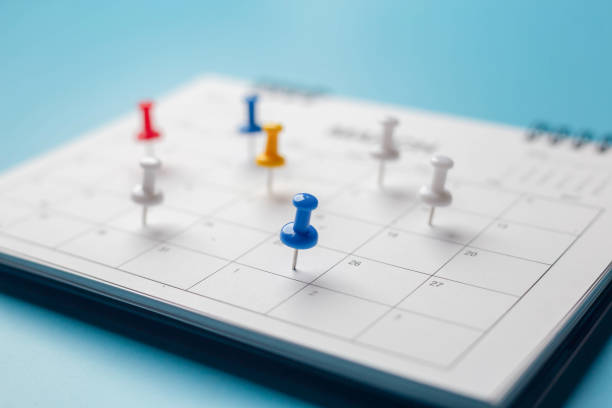 istock Calendar on solid blue background with copy space, pinned in a calender on datebusiness meeting schedule. 1299442935
