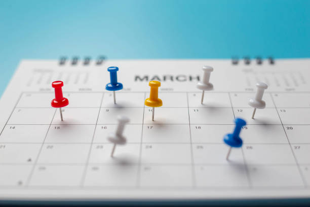 istock Calendar on solid blue background with copy space, pinned in a calender on datebusiness meeting schedule. 1299442942