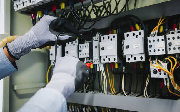 istock Electrical engineers test electrical installations and wiring on protective relays, measuring them with a multimeter. 1299443001