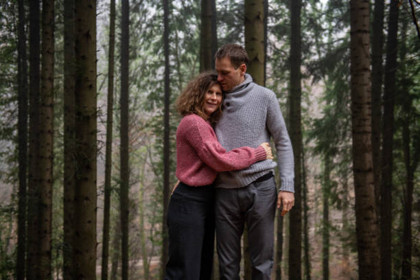 istock Adult Couple posing in the Spruce Forest 1299443540