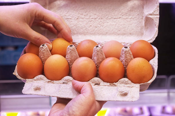 istock Eggs in a cardboard box in the supermarket. 1299444220