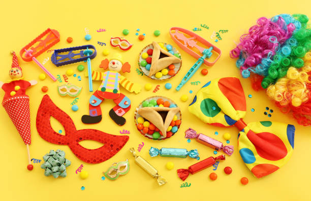 istock Purim celebration concept (jewish carnival holiday) over yellow background. Top view, flat lay 1299444301
