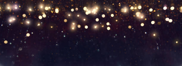 istock background of abstract gold and black glitter lights. defocused 1299444358