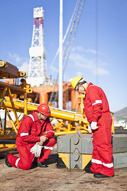 Workers On Oil Rig Examining Equipment Stock Photo - Download Image Now -  Offshore Platform, Drilling Rig, Men - iStock