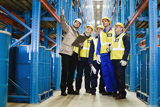 Workers talking in warehouse  drum container stock pictures, royalty-free photos & images