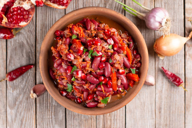 istock Stewed broad beans in tomato sauce with herbs and spices on the table. Top view 1299446923