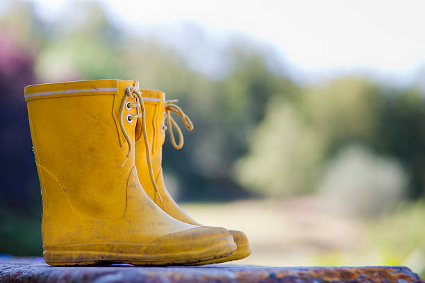 Close up of child's rainboots  yellow shoes stock pictures, royalty-free photos & images