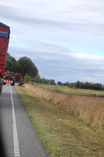 istock Driving behind a working tractor cutting the grass of the ditch. 1299449223