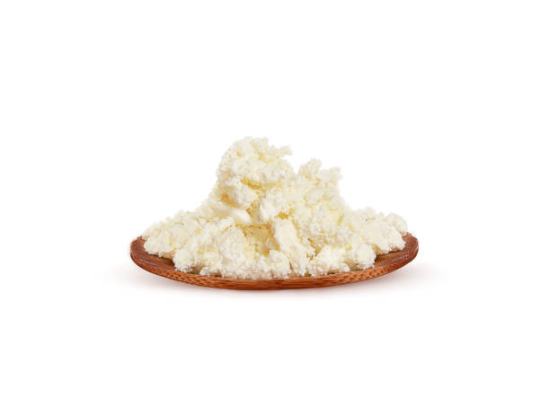 istock fresh cottage cheese on a wood plate on a white background 1299449729