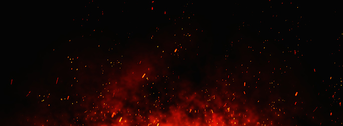 Partículas de brasas de fuego sobre fondo negro. photo