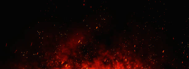 Fire embers particles over black background. Fire sparks background. Abstract dark glitter fire particles lights. bonfire in motion blur. fire stock pictures, royalty-free photos & images