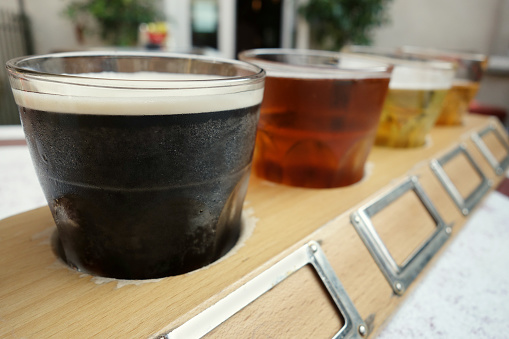 A flight of craft beers at a brewery outdoor patio