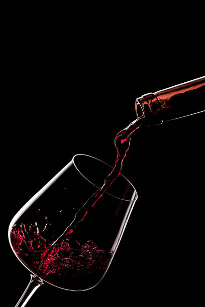 istock Pouring red wine in a glass 1299458895