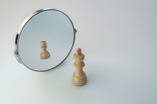 istock Chess King  looking in the Mirror and seeing a Pawn. 1299459620