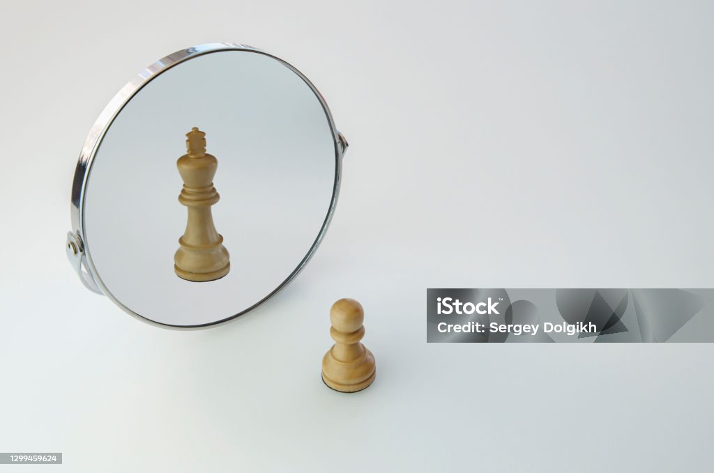 Chess Pawn imagining itself as a King,  pawn in a Mirror being a king Vanity Stock Photo