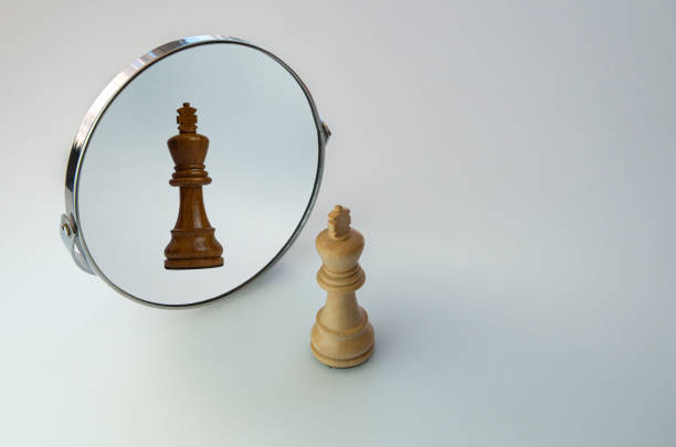 istock White Chess King looks in the mirror and sees the Black King. 1299459625