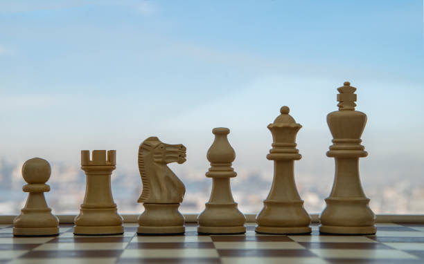 istock Chess board and pieces in a chess game. Empty place for text. 1299460006