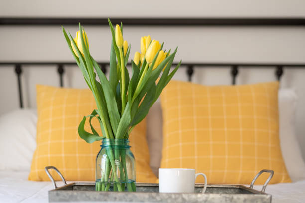 istock Tray with tulips and a coffee cup on the bed 1299460038