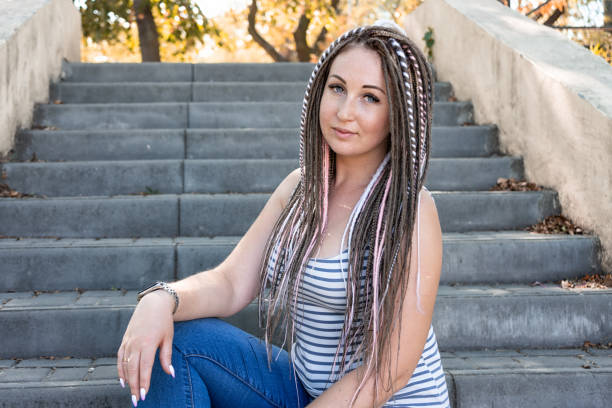 glücklich mädchen mit sommersprossen und dreadlocks. porträt von schönen jungen frau mit zöpfen. helle stilvolle mädchen in brille - braided women sensuality portrait stock-fotos und bilder