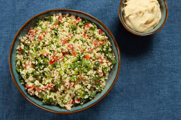 Tabbouleh Salad Tabbouleh (also called tabouleh, tabbouli, tabouli, or taboulah) is a Levantine vegetarian salad made mostly of finely chopped parsley, with tomatoes, mint, onion, bulgur wheat, and seasoned with olive oil, lemon juice, salt and sweet pepper. On blue tablecloth couscous stock pictures, royalty-free photos & images